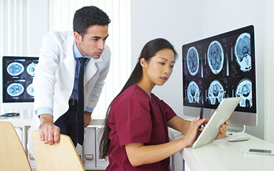 Doctor and medical assistant looking at MRI results